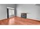 Spacious living room featuring a fireplace, hardwood floors, large windows, and neutral paint at 198 Winterport St, Henderson, NV 89074