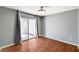 Living room featuring hardwood floors, sliding glass door, and modern ceiling fan at 198 Winterport St, Henderson, NV 89074