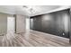 Main bedroom with stylish flooring, dark accent wall, closet, and ensuite bathroom at 198 Winterport St, Henderson, NV 89074