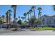 View of the gated community entrance with palm trees and well-manicured landscaping at 2615 W Gary Ave # 2061, Las Vegas, NV 89123