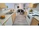 Kitchen view showcasing white appliances and wooden cabinets in an open-concept layout at 2615 W Gary Ave # 2061, Las Vegas, NV 89123