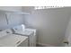 Compact laundry room with a stacked washer and dryer set against a white wall at 2615 W Gary Ave # 2061, Las Vegas, NV 89123