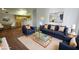 A staged living room features contemporary furniture, an open floor plan, and hardwood floors at 2615 W Gary Ave # 2061, Las Vegas, NV 89123