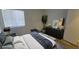 A staged main bedroom with a large window, plant, and dark dresser at 2615 W Gary Ave # 2061, Las Vegas, NV 89123