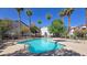 Community pool and lounge area surrounded by trees, offering a peaceful retreat at 2615 W Gary Ave # 2061, Las Vegas, NV 89123