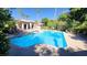 Serene community pool surrounded by tropical landscaping and comfortable lounge chairs at 2615 W Gary Ave # 2061, Las Vegas, NV 89123