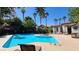 Inviting community pool with palm trees and lounge chairs under a clear, sunny sky at 2615 W Gary Ave # 2061, Las Vegas, NV 89123