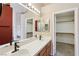 Bathroom featuring double sinks, white tile countertops, and walk-in closet at 2717 Pastel Ave, Henderson, NV 89074
