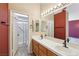 Bathroom featuring double sinks, white tile countertops, and walk-in shower at 2717 Pastel Ave, Henderson, NV 89074