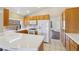 Charming kitchen features white appliances, tile countertops, and wooden cabinetry at 2717 Pastel Ave, Henderson, NV 89074