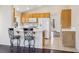 Bright kitchen with white appliances, breakfast bar, and tile flooring at 2717 Pastel Ave, Henderson, NV 89074