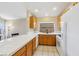 Well-lit kitchen featuring tile countertops, wooden cabinets, and stainless steel appliances at 2717 Pastel Ave, Henderson, NV 89074