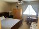 Bright bedroom with a ceiling fan and a desk with a wooden chair at 2750 S Durango Dr # 2141, Las Vegas, NV 89117