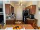 Eat-in kitchen features wood cabinets, granite countertops, and modern appliances at 2750 S Durango Dr # 2141, Las Vegas, NV 89117