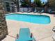 A serene pool area with clear blue water and a row of lounge chairs at 2750 S Durango Dr # 2141, Las Vegas, NV 89117