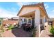 An inviting backyard features a covered patio, a relaxing hot tub, and multiple seating areas, perfect for relaxing and entertaining at 2845 Mincio St, Henderson, NV 89044
