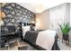 Stylish bedroom with a black accent wall, a unique desk, and a large window with natural light at 2845 Mincio St, Henderson, NV 89044