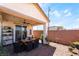The covered patio features a dining set and leads to a nicely landscaped backyard, providing an outdoor relaxation space at 2845 Mincio St, Henderson, NV 89044