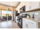 Well-appointed kitchen featuring stainless steel appliances, granite countertops, and a view of the outdoor patio at 2845 Mincio St, Henderson, NV 89044