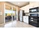 Modern kitchen with stainless steel appliances, white cabinets, and a view of the outdoor entertainment space at 2845 Mincio St, Henderson, NV 89044