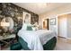 Beautiful bedroom with statement wallpaper, a decorative mirror, and access to an ensuite bathroom at 2845 Mincio St, Henderson, NV 89044