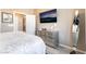 Bedroom with a wall-mounted TV, stylish dresser, full-length mirror and plush carpeting at 2845 Mincio St, Henderson, NV 89044