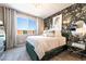 Modern main bedroom featuring a large window, an accent wall, a beautiful chandelier, and stylish decor at 2845 Mincio St, Henderson, NV 89044