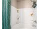Close up on a white tile shower tub with a shower curtain and a built-in storage niche at 2845 Mincio St, Henderson, NV 89044