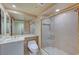 Bathroom featuring a tiled walk-in shower, neutral decor, and granite counters at 2877 Paradise Rd # 2105, Las Vegas, NV 89109