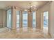 Bright and airy living room with tile floor, stylish light fixture, and multiple windows offering city views at 2877 Paradise Rd # 2105, Las Vegas, NV 89109