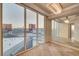 Bright living area boasts an elegant chandelier, mirrored wall, and a large window framing an urban view at 2877 Paradise Rd # 2105, Las Vegas, NV 89109