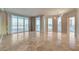 Spacious living room featuring sleek tile flooring, neutral walls, and floor-to-ceiling windows with city views at 2877 Paradise Rd # 2105, Las Vegas, NV 89109