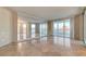 Bright living room with tile flooring, large mirror accent, and panoramic city views through expansive windows at 2877 Paradise Rd # 2105, Las Vegas, NV 89109