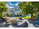 Inviting backyard featuring a covered patio seating area, manicured lawn, and beautiful outdoor space at 2920 Sterling Cove Dr, Las Vegas, NV 89128