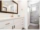 Modern bathroom featuring sleek vanity with white countertop, a large mirror, and a glass-enclosed shower at 2920 Sterling Cove Dr, Las Vegas, NV 89128