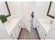 Bathroom with double sink, white countertops, and a view to the next floor at 2920 Sterling Cove Dr, Las Vegas, NV 89128