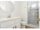 Modern bathroom featuring a glass enclosed shower, vanity with sink, and round mirror at 2920 Sterling Cove Dr, Las Vegas, NV 89128