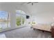 Bedroom featuring large windows overlooking a lake and vaulted ceilings at 2920 Sterling Cove Dr, Las Vegas, NV 89128