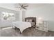 Bright bedroom with neutral tones featuring a large window, a comfortable bed, and modern furnishings at 2920 Sterling Cove Dr, Las Vegas, NV 89128
