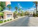 Gated community entrance with brick columns, decorative tile, and mature palm trees at 2920 Sterling Cove Dr, Las Vegas, NV 89128