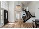 Spacious entryway featuring a chandelier, staircase, and lots of natural light at 2920 Sterling Cove Dr, Las Vegas, NV 89128