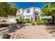 Elegant two-story home with desert landscaping, a tile roof, and a three-car garage at 2920 Sterling Cove Dr, Las Vegas, NV 89128