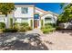 Charming two-story home features a tile roof, arched entry, desert landscaping, and manicured bushes at 2920 Sterling Cove Dr, Las Vegas, NV 89128