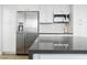 Kitchen featuring stainless steel refrigerator, microwave, and gray countertop island at 2920 Sterling Cove Dr, Las Vegas, NV 89128