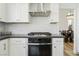 Modern kitchen features white cabinetry, stainless steel range hood, textured backsplash, and gas cooktop at 2920 Sterling Cove Dr, Las Vegas, NV 89128