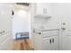 Well-lit laundry room with a utility sink, storage cabinets, and a convenient bench at 2920 Sterling Cove Dr, Las Vegas, NV 89128