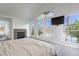 Spacious bedroom with fireplace and large windows with beautiful lake views at 2920 Sterling Cove Dr, Las Vegas, NV 89128
