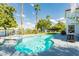 Beautiful pool with a spa and lake view, surrounded by palm trees and a well-maintained lawn at 2920 Sterling Cove Dr, Las Vegas, NV 89128