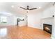 Bright living room with hardwood floors, fireplace, and view into the kitchen at 3060 Tarpon Dr # 104, Las Vegas, NV 89120