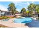Community pool featuring a hot tub and surrounded by lush greenery, creating a relaxing oasis for residents at 3060 Tarpon Dr # 104, Las Vegas, NV 89120